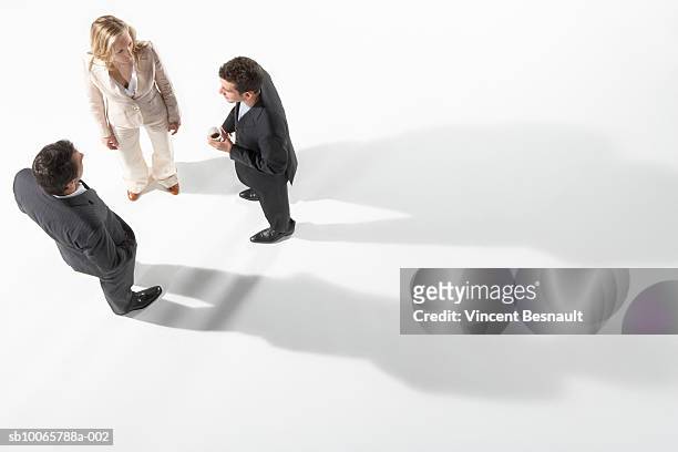 three business people talking together - businessman high angle stock-fotos und bilder