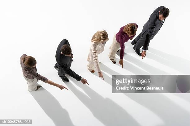 row of business people pointing, overhead view - exigir fotografías e imágenes de stock