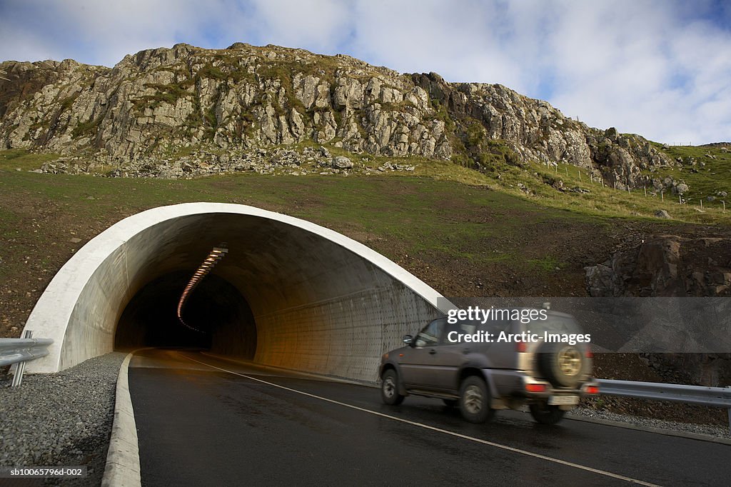 Sports Utility Vehicle entering mountain tunnel