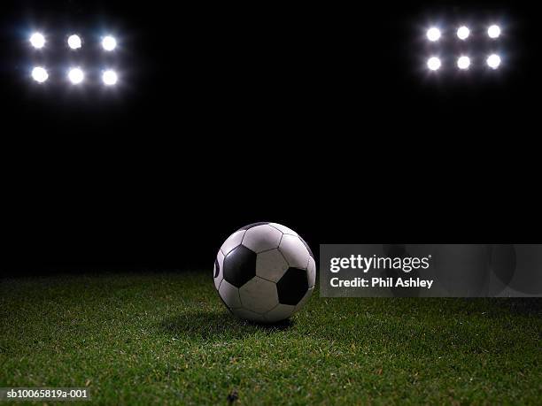 football on stadium's lawn - floodlight stockfoto's en -beelden