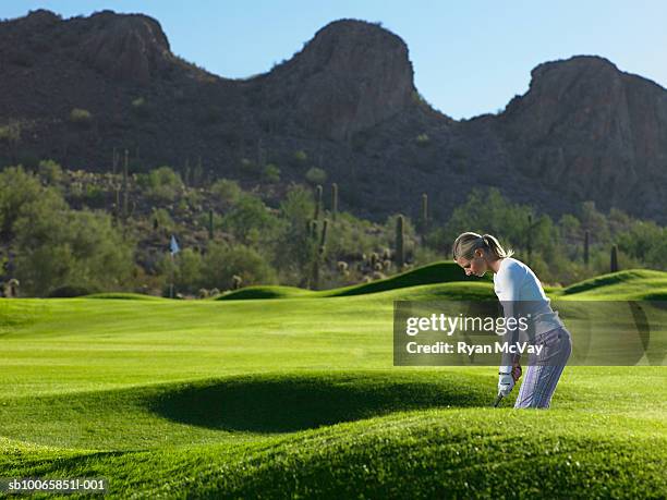 woman playing golf on course - arizona golf stock pictures, royalty-free photos & images