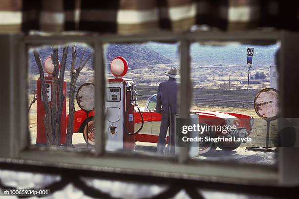 view from window of person standing at gas station (focus on background) - route 66 stock-fotos und bilder