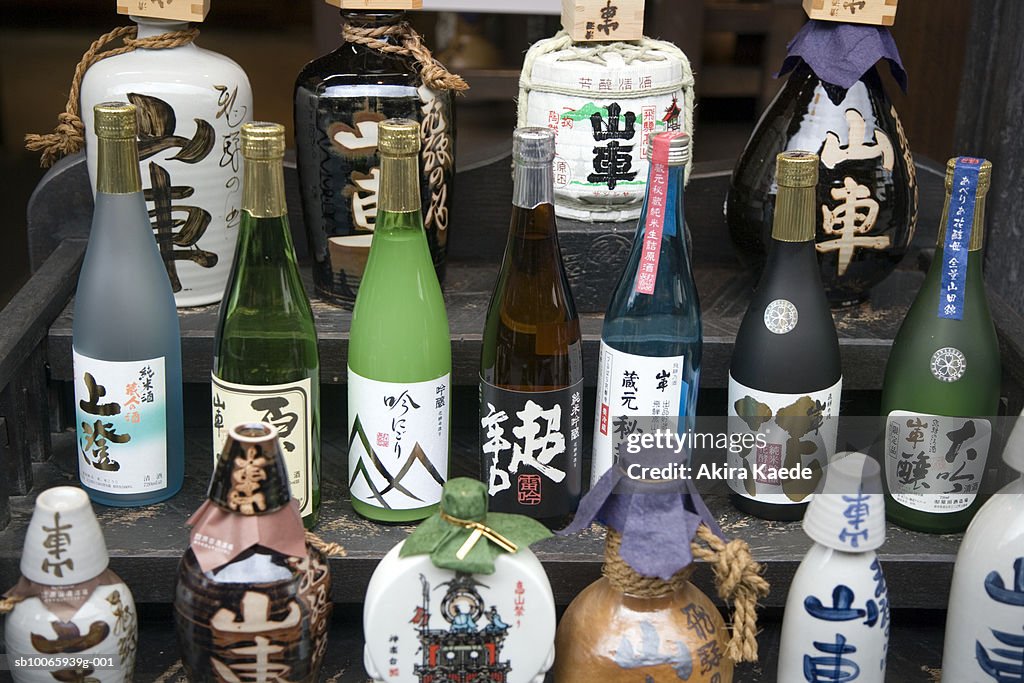 Collection of sake bottles on steps