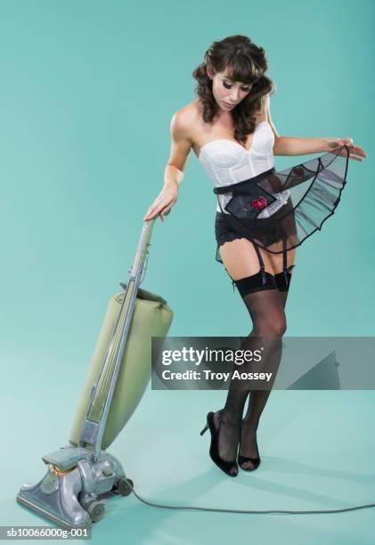 young woman in lingerie with vacuum cleaner - 40s pin up girls stock pictures, royalty-free photos & images