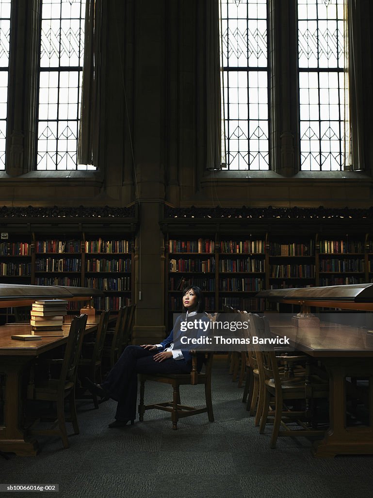 Young woman sitting in university library