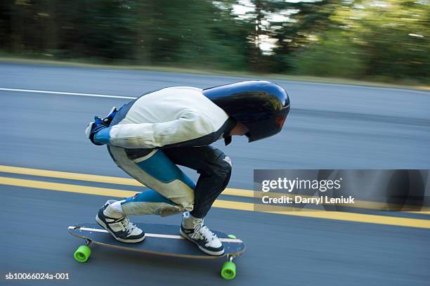 longboarder on road, side view - extreme skating stock pictures, royalty-free photos & images