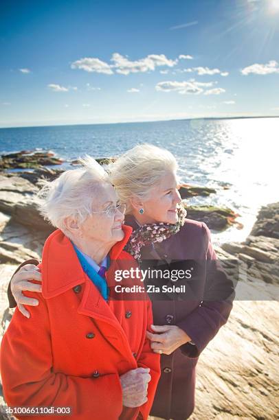 two women standing at beach, smiling - jamestown stock pictures, royalty-free photos & images