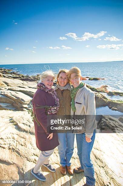three women standing at beach, smiling, portrait - jamestown stock pictures, royalty-free photos & images