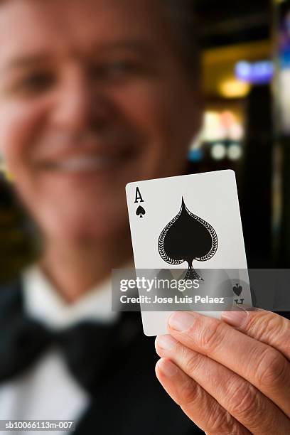 senior man holding ace of spades, close-up - ace of spades stock pictures, royalty-free photos & images