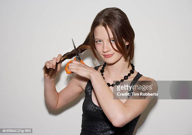 young woman cutting hair, smiling, portrait - human hair stockfoto's en -beelden