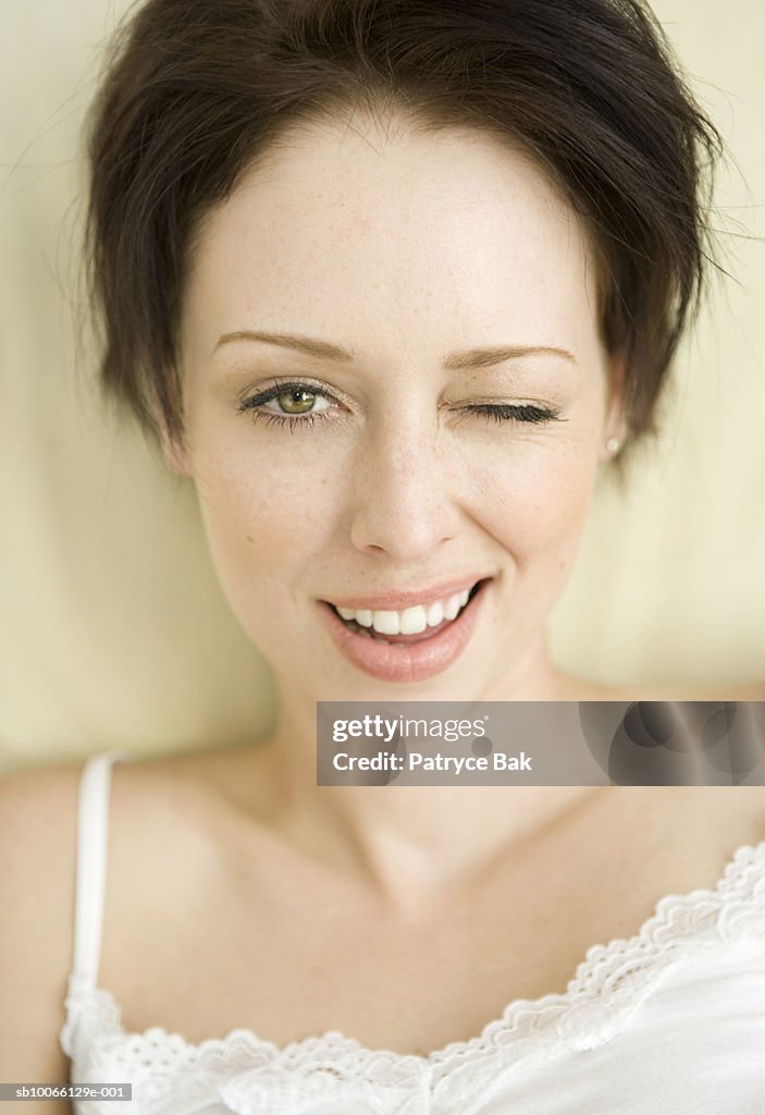 Young woman winking, portrait, close-up