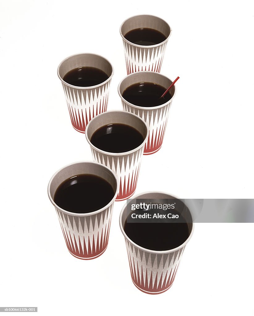 Paper cups with black coffee on white background
