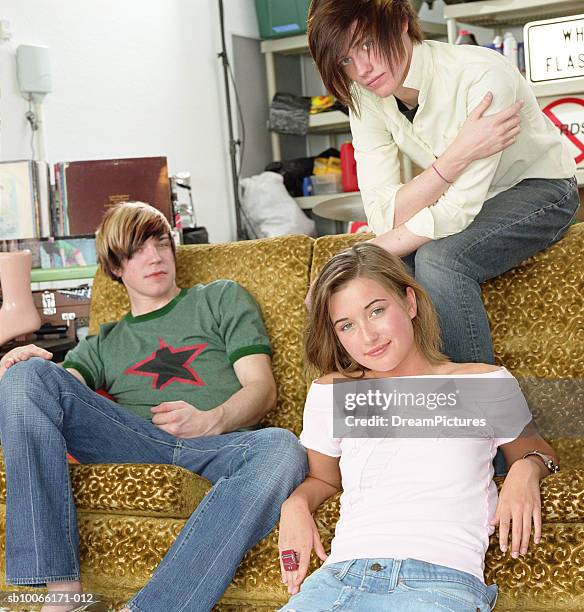 three teenage friends (17-18) sitting on couch in garage, portrait - emo guy stock pictures, royalty-free photos & images