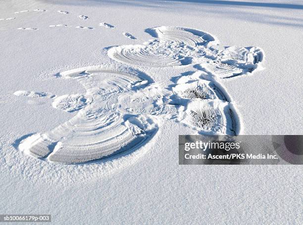 snow angel in snow, elevated view - snow angel stock pictures, royalty-free photos & images