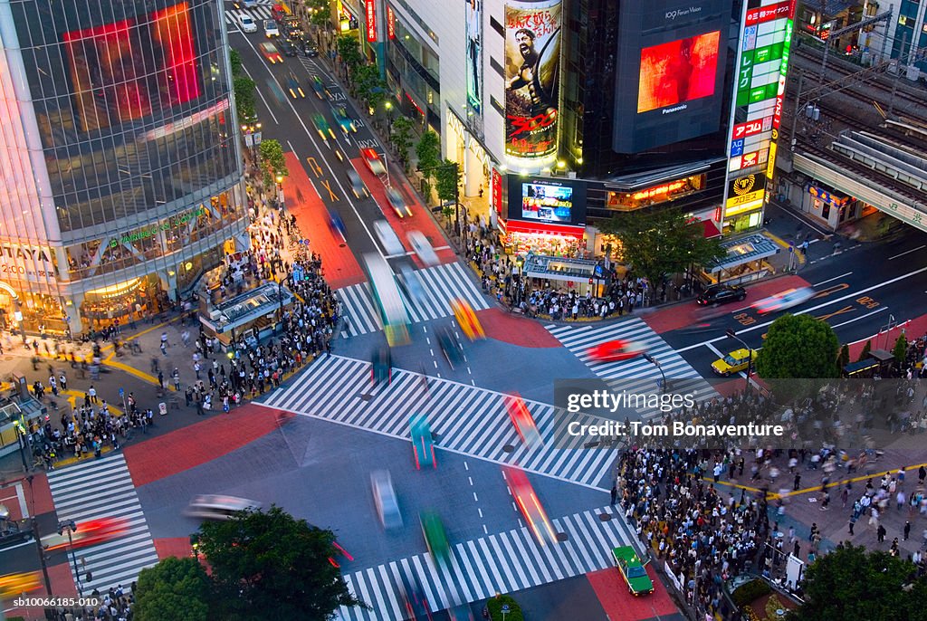 Japan, Tokyo, pedestrians on Shibuya crossing in evening, elevated view