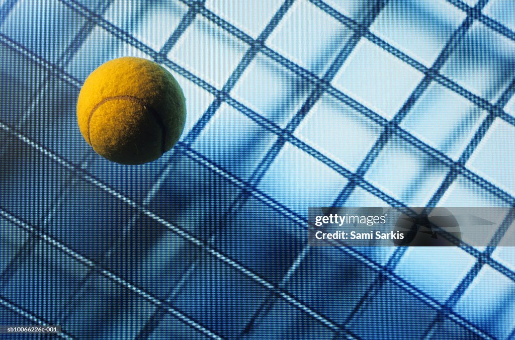 Tennis ball on TV screen displaying racket's wire mesh