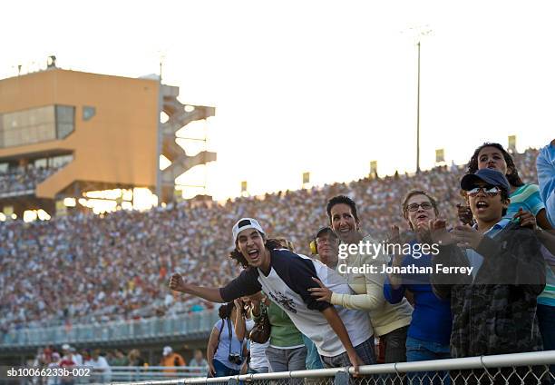 crowd in stadium watching stock car racing, cheering - sportevenement stockfoto's en -beelden