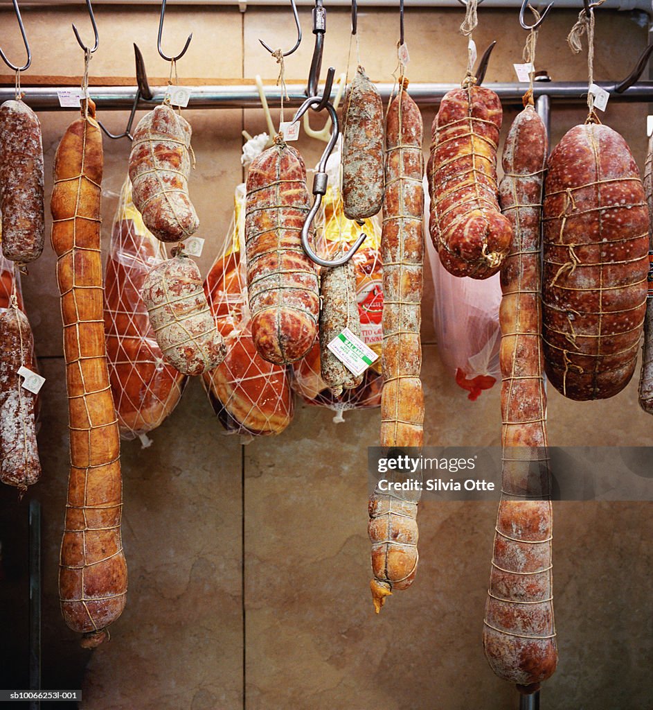 Salami and sausages hanging in shop