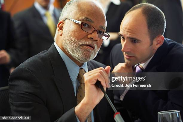 two businessmen whispering, close-up - chief financial officers stock pictures, royalty-free photos & images