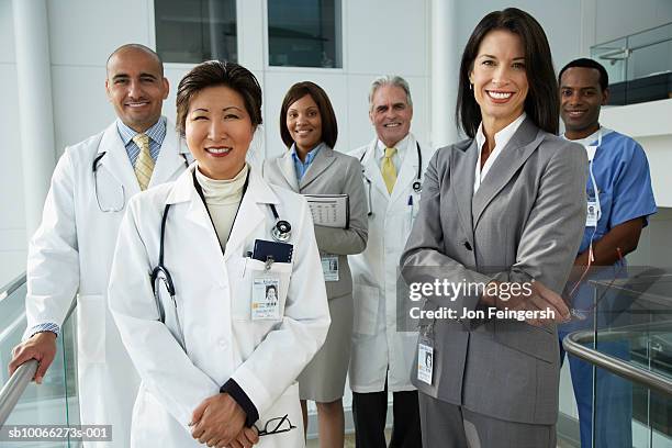 two businesswomen with doctors, smiling, portrait - arab businesswoman with books fotografías e imágenes de stock