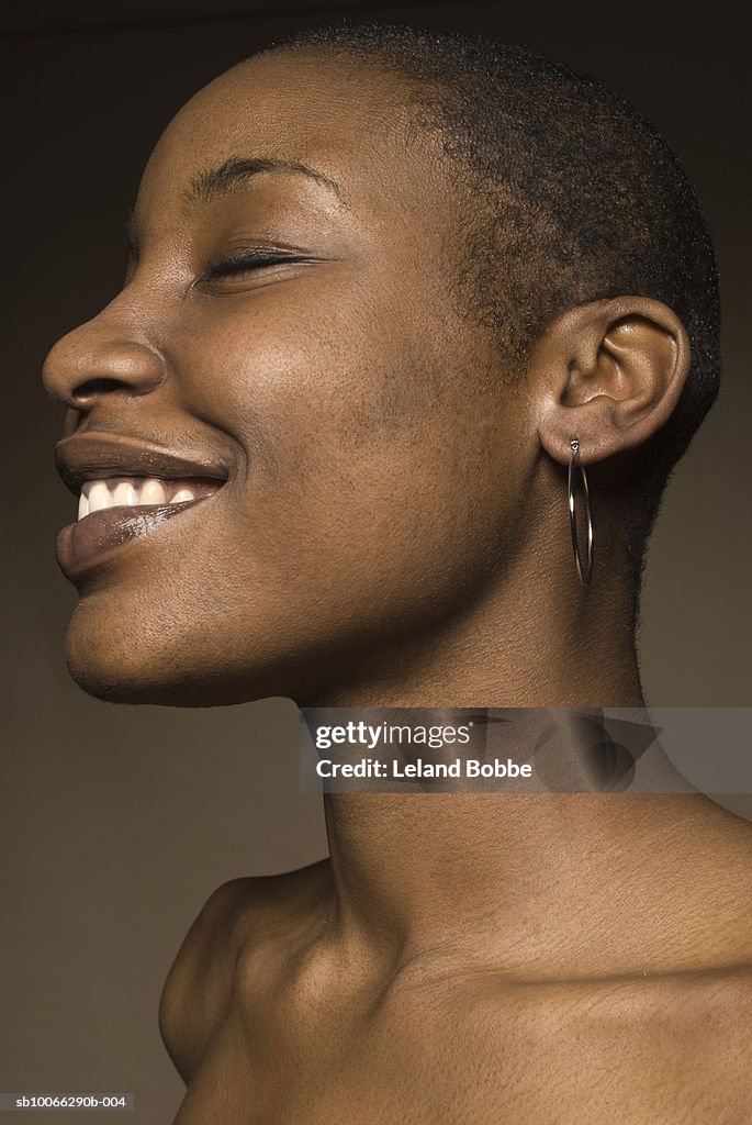 Young woman with eyes closed, smiling, close-up