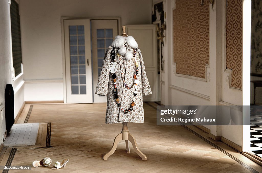 Miniature coat on tailor's dummy in doll house living room
