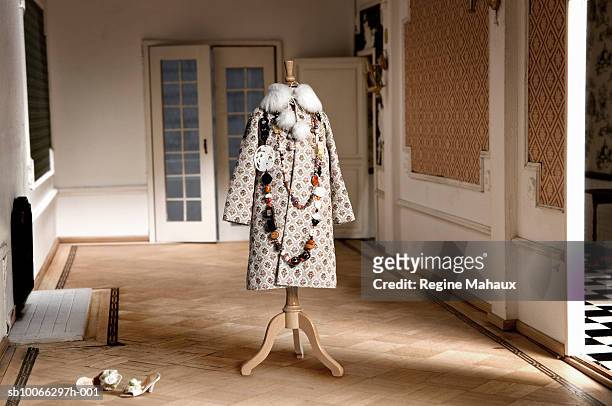 miniature coat on tailor's dummy in doll house living room - overcoat stock pictures, royalty-free photos & images