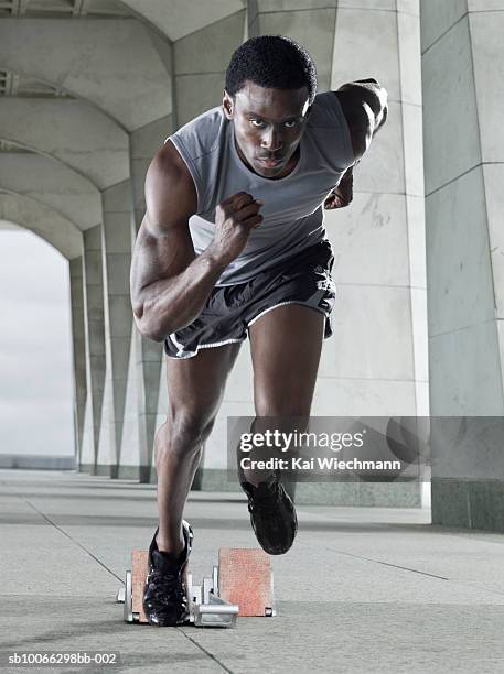 runner leaving starting blocks - sprinting photos et images de collection