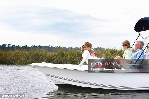 family including boy (15-18 months) relaxing on boat - casual southern stock pictures, royalty-free photos & images