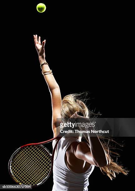 female tennis player serving, rear view - tennis racket imagens e fotografias de stock