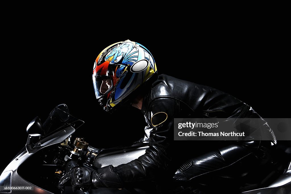 Motorcyclist on motorbike, side view
