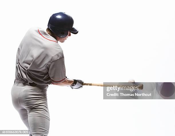 baseball player swinging bat, rear view - bastão de basebol imagens e fotografias de stock
