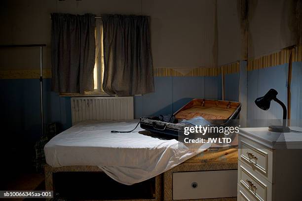 open suitcase on bed - bad condition stock pictures, royalty-free photos & images