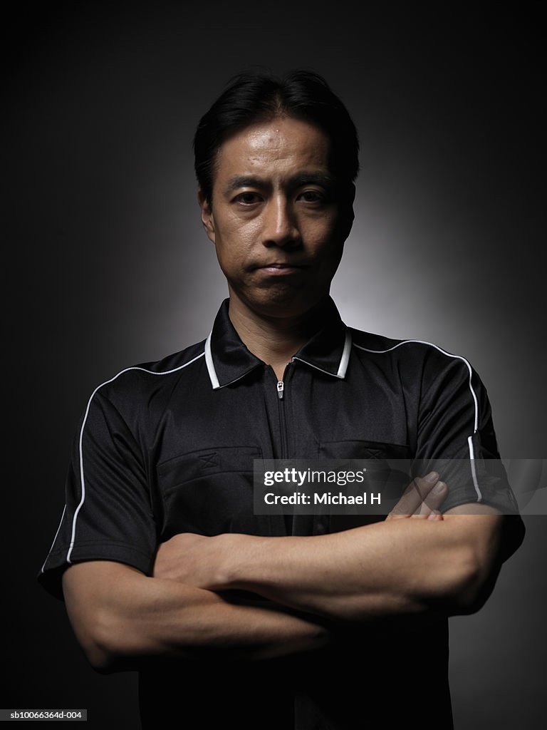 Soccer referre with arms crossed, portrait, close-up