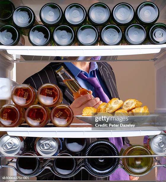 business man taking beer from fridge - beer fridge stock-fotos und bilder