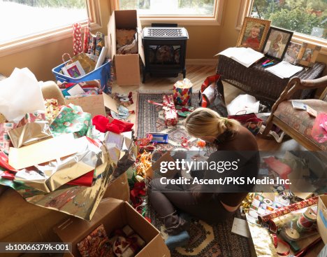 Woman sitting in living room writing on Christmas cards, elevated view Woman sitting in living room writing on Christmas cards, elevated view