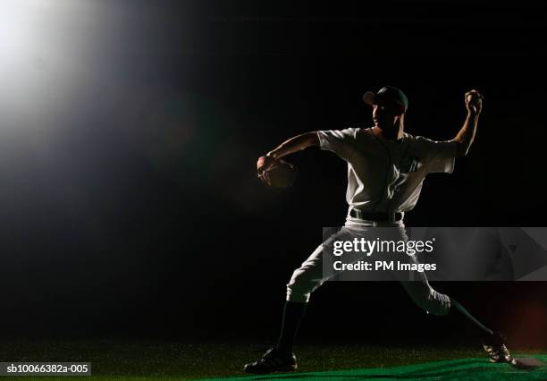 baseball pitcher releasing ball - baseball pitcher stock pictures, royalty-free photos & images