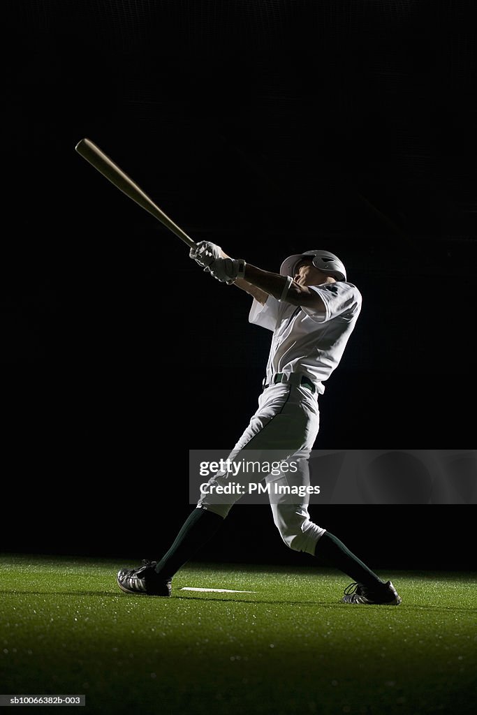 Baseball batter swinging bat, side view