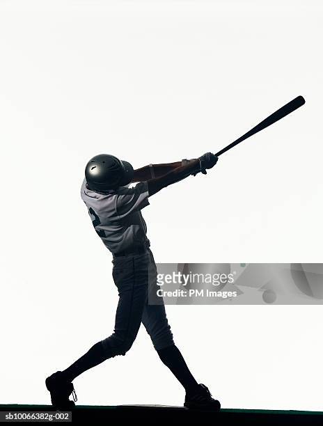 silhouette of baseball batter swinging bat, side view - bastão de basebol imagens e fotografias de stock