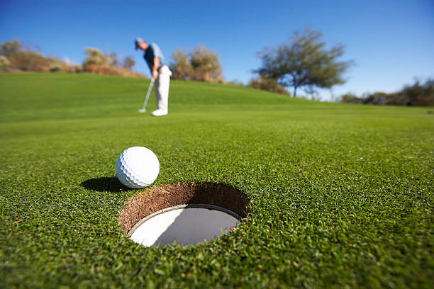 male golfer putting on golf course - golf balls stock pictures, royalty-free photos & images
