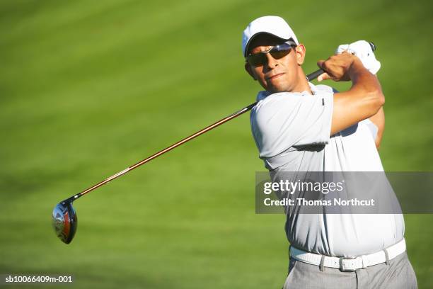 male golfer on golf course - golf sport fotografías e imágenes de stock