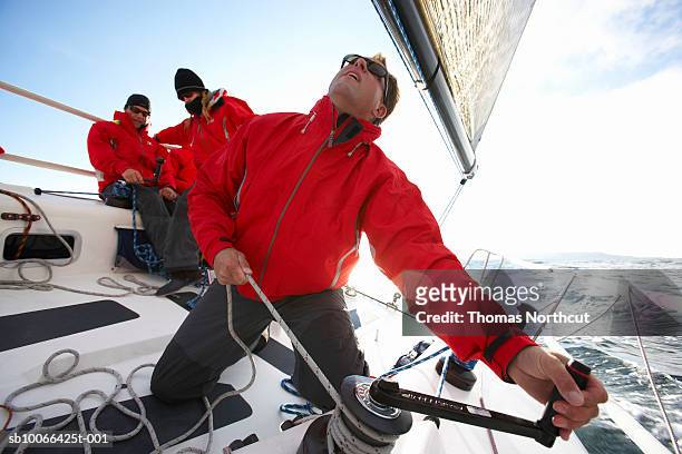 crew sailing racing yacht - segeln stock-fotos und bilder