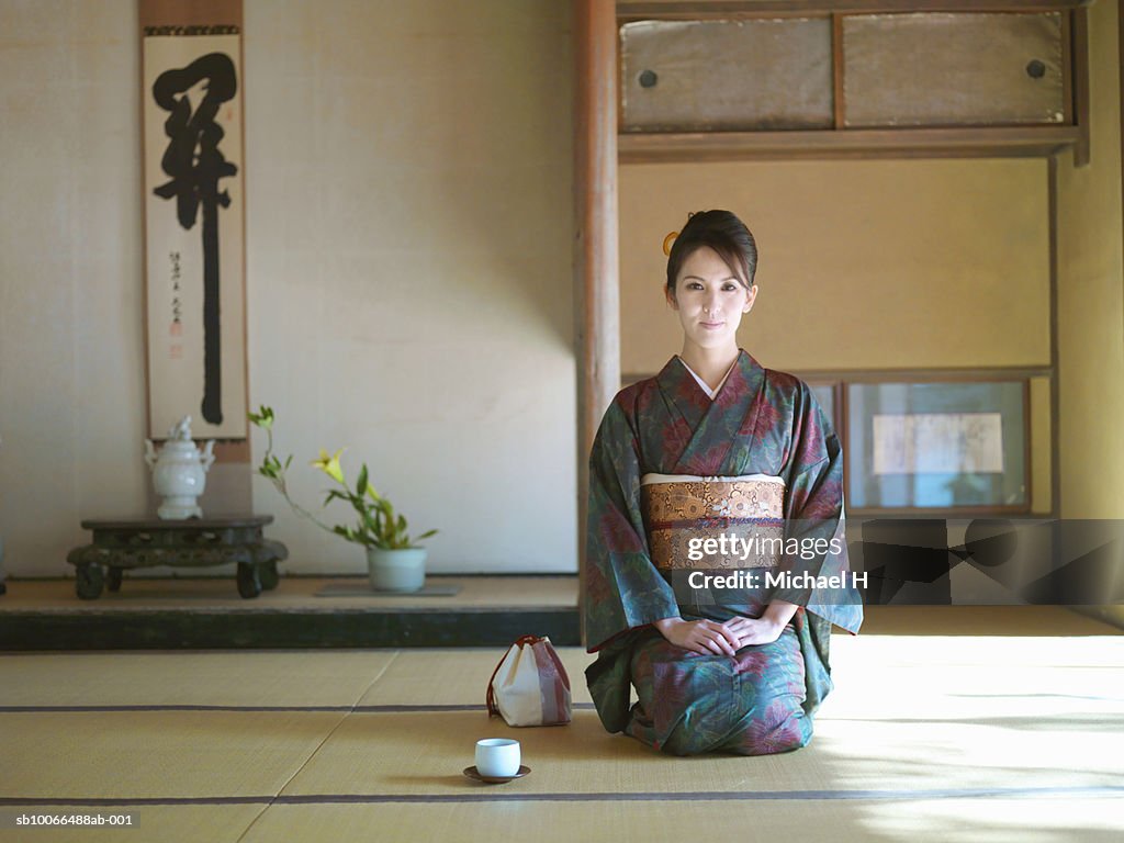 Japan, Kyoto, Enko Temple, woman in kimono kneeling in temple, portrait