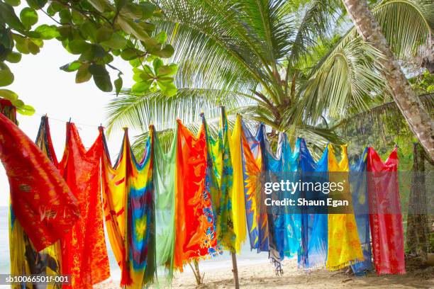 colourful sarongs hanging on clothesline on beach - trinidad und tobago stock-fotos und bilder