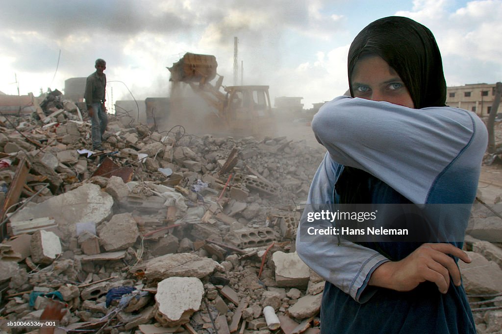 Lebanon, Sidiken, Girl in destroyed town covering mouth from ashes, portrait