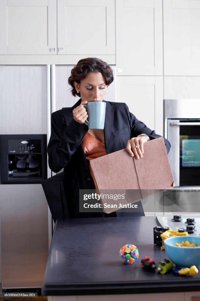 Woman drinking coffee in kitchen