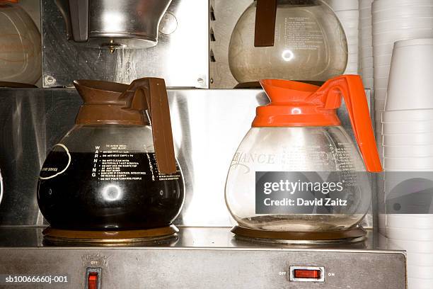 coffee pots on brewing machine, close-up - koffiepot stockfoto's en -beelden