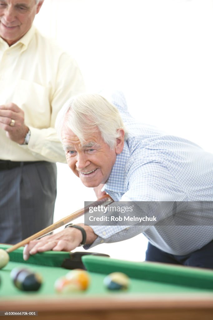 Two senior men playing pool, indoors