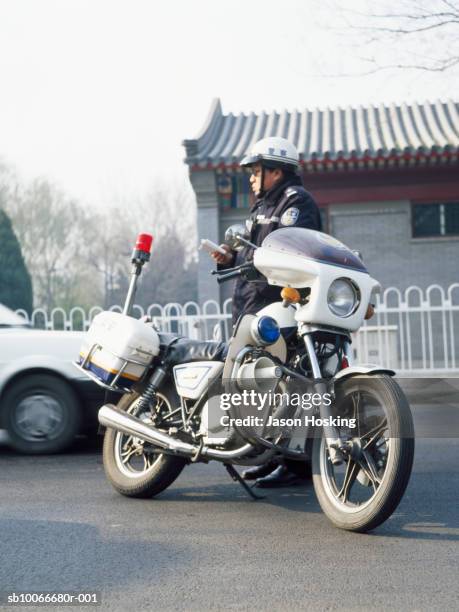 police officer writing ticket - police motorbike stock pictures, royalty-free photos & images