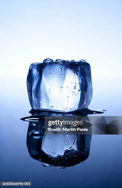 melting ice cube and reflection, close-up - ice cube stock pictures, royalty-free photos & images